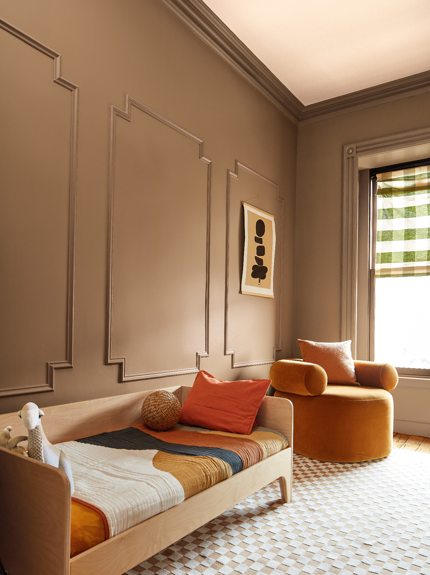 Warm kids' bedroom with Chowning Tan walls and burnt-orange accents