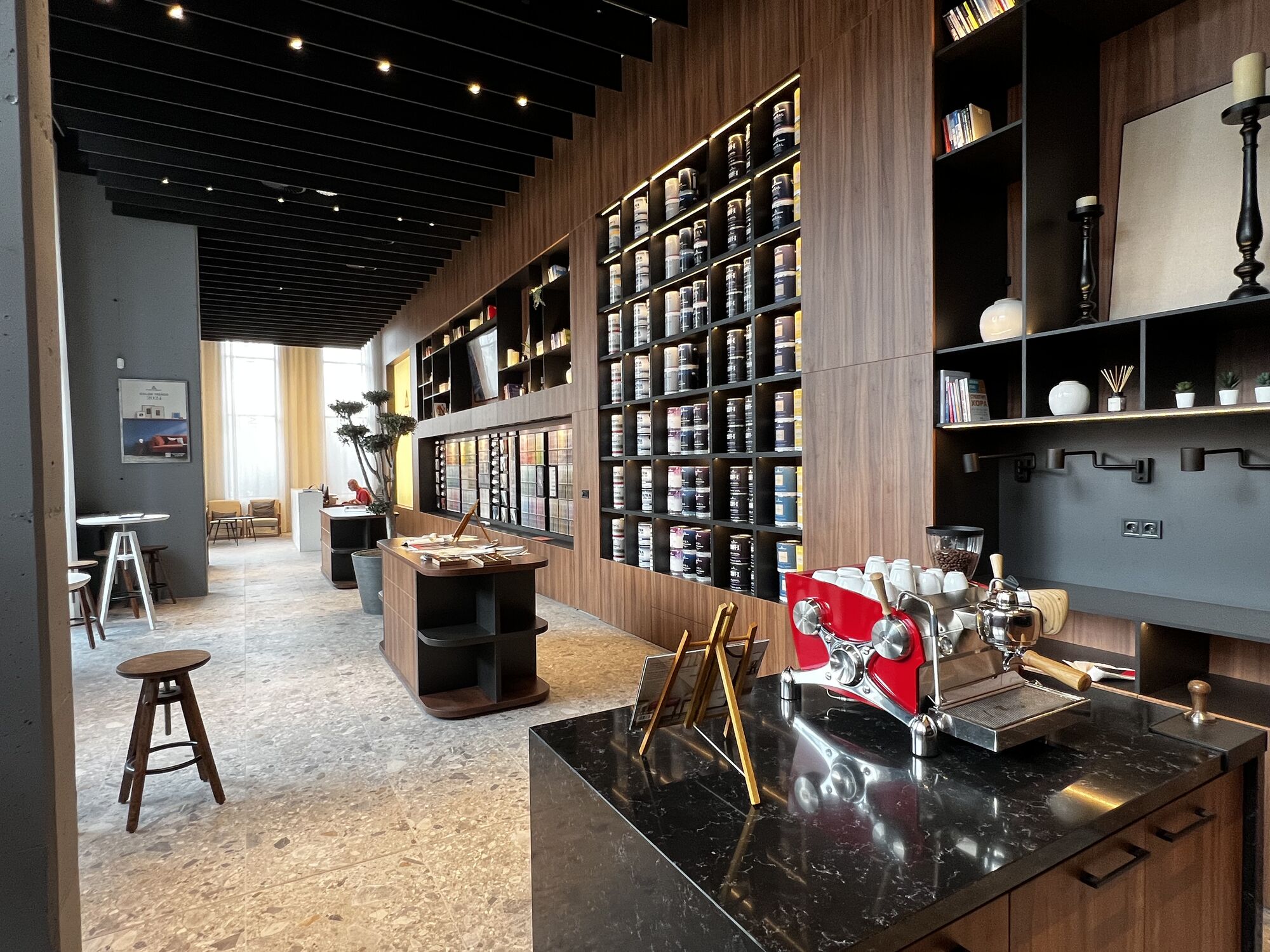 Benjamin Moore Bulgaria showroom — paint can wall and espresso bar